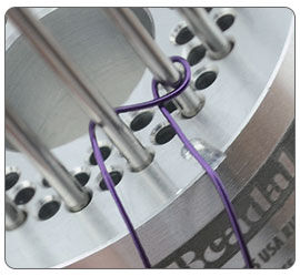Wire being wrapped around jig pegs
